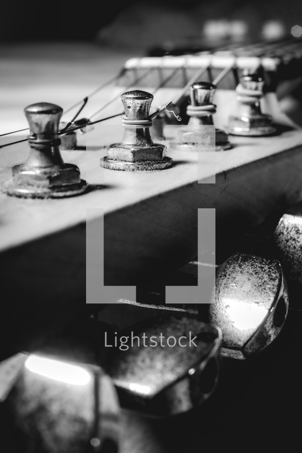 Close up from an old vintage guitar headstock , Full with dust. In black and white.