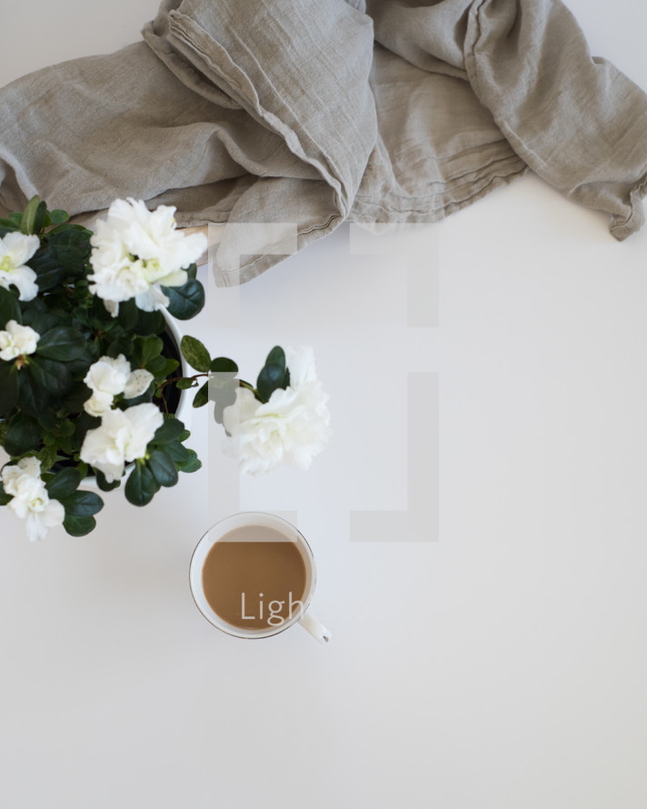 white flowers, linen fabric, coffee cup 