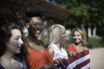 women holding an American flag 
