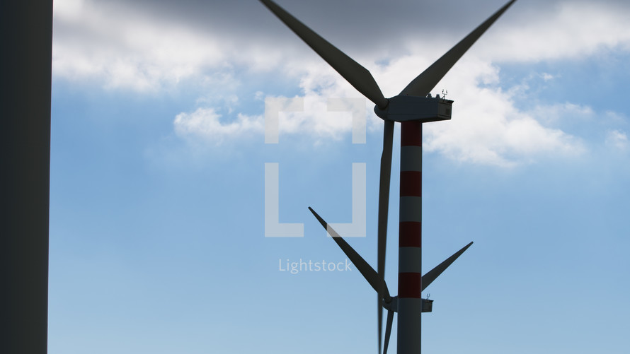 Silhouette of Wind energy and turbines against blue sky