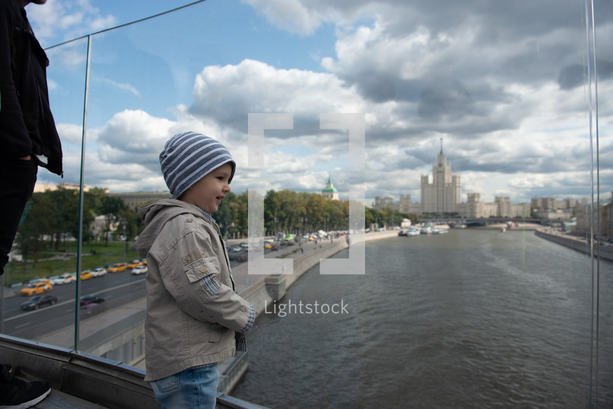 boy looking out at a river 