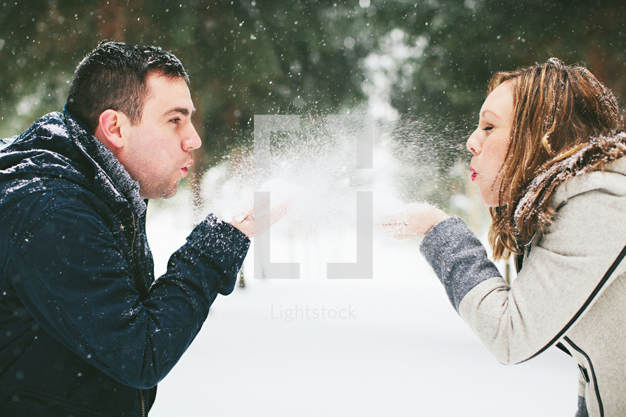 couple playing in snow 