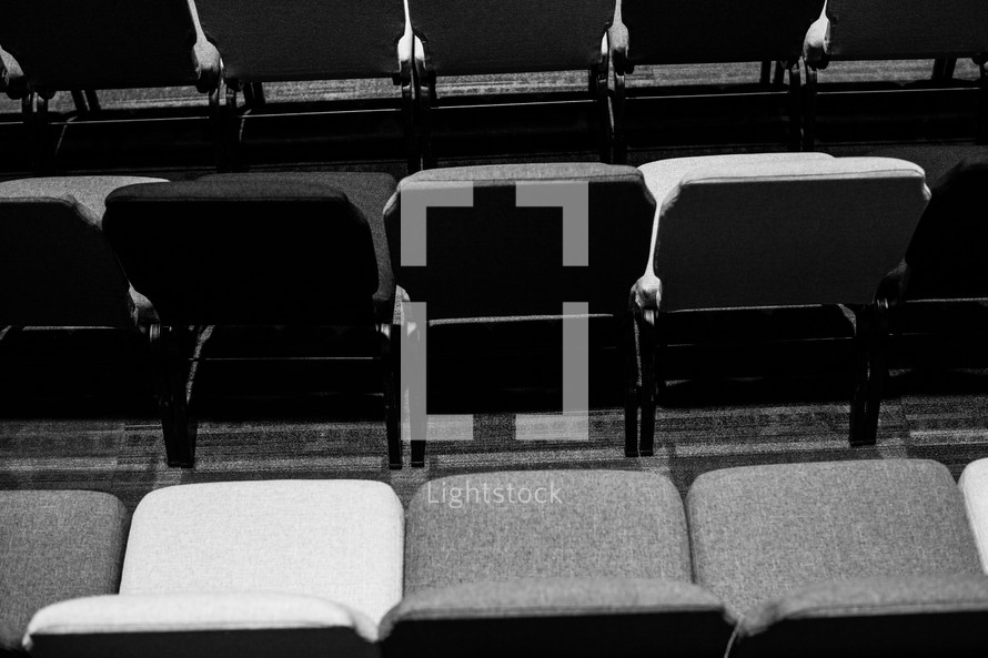 rows of auditorium chairs 