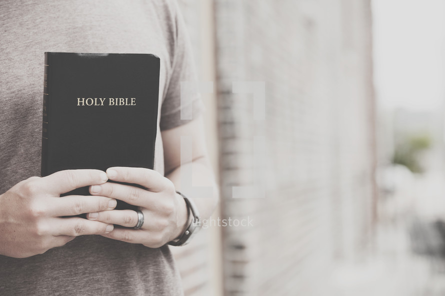 man holding a Bible against his chest