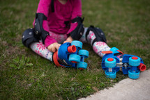 child putting on roller skates 