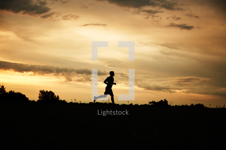 silhouette of a man running 