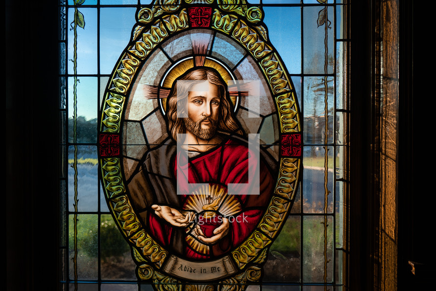 Stained glass window of Flaming Sacred Heart.
