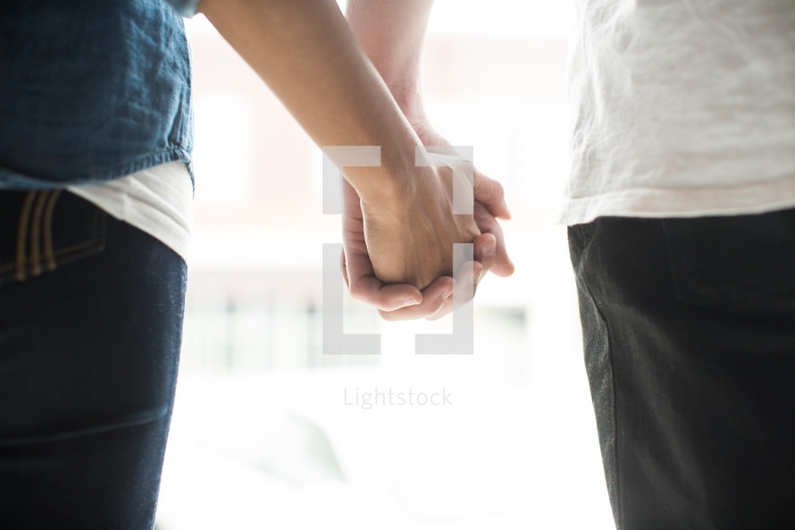 a couple holding hands 