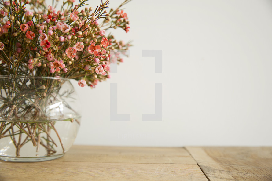 flowers in a vase on a wood table 