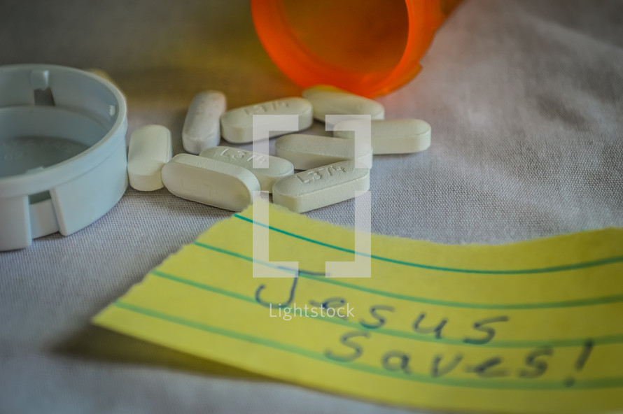 pills with a paper that has Jesus saves written on it