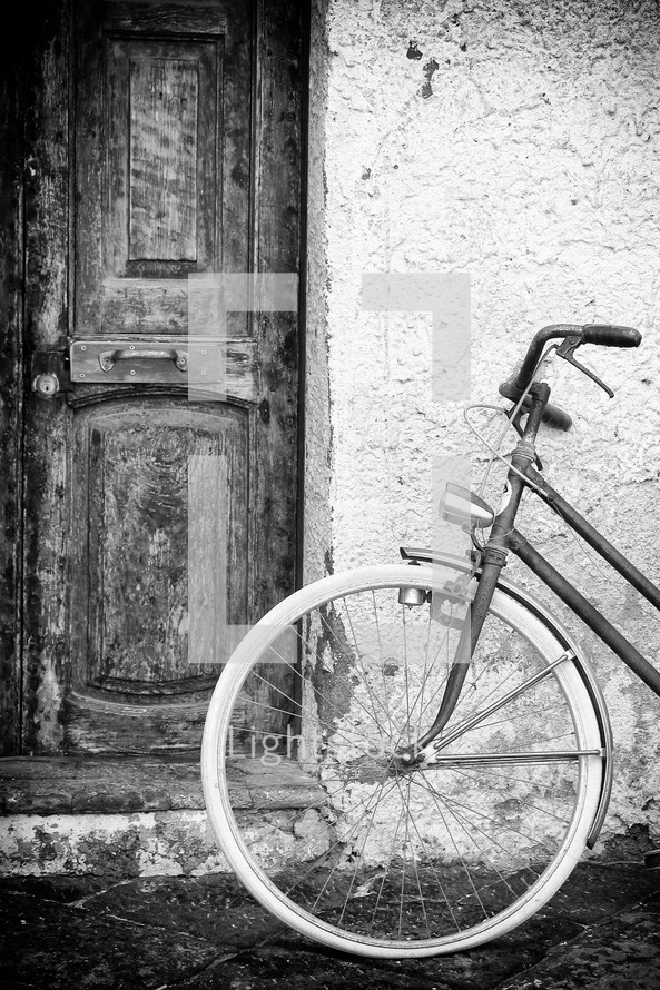Old doors and wall with vintage bike, black and white shot