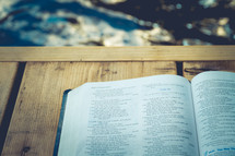 opened Bible on a dock 