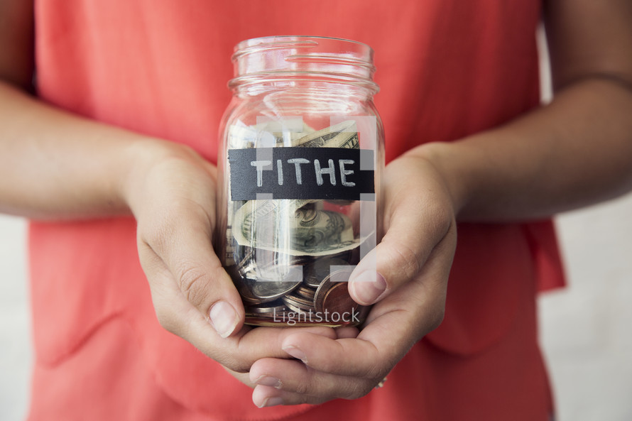woman holding a tithe jar 