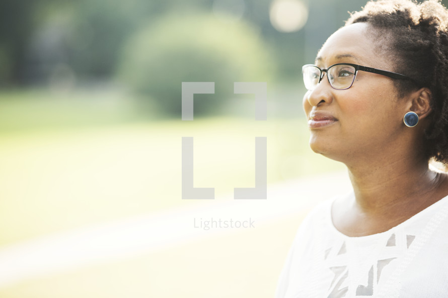 side profile of a woman's face with reading glasses