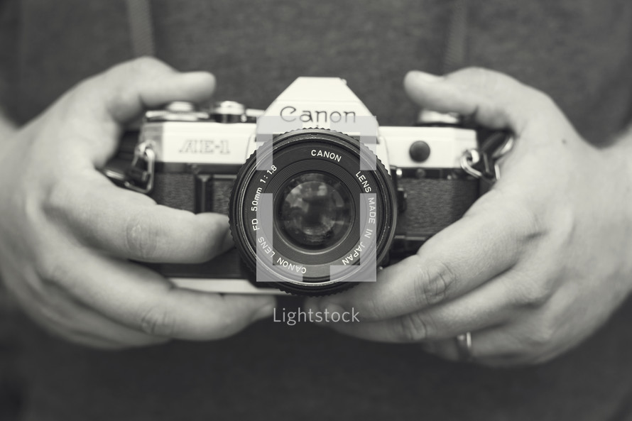 hands holding a camera 