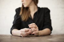 A woman playing with her wedding ring on her finger.
