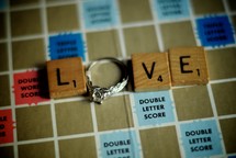 word love out of scrabble pieces and engagement ring 
