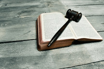 judges mallet on the pages of a Bible 
