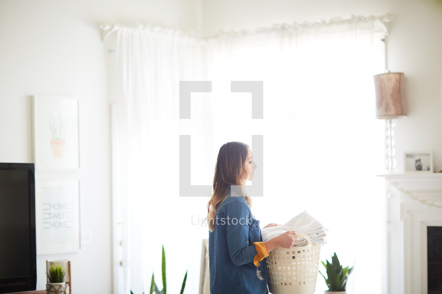 a woman carrying a laundry basket 