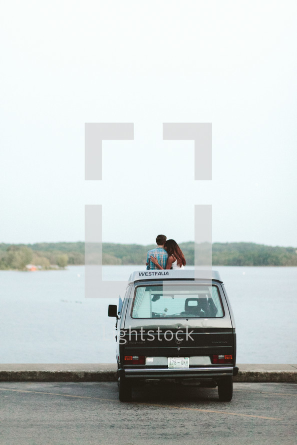 a couple standing with a VW van