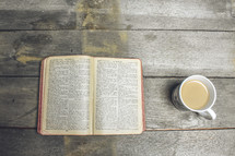 pages of a Bible and a coffee mug 