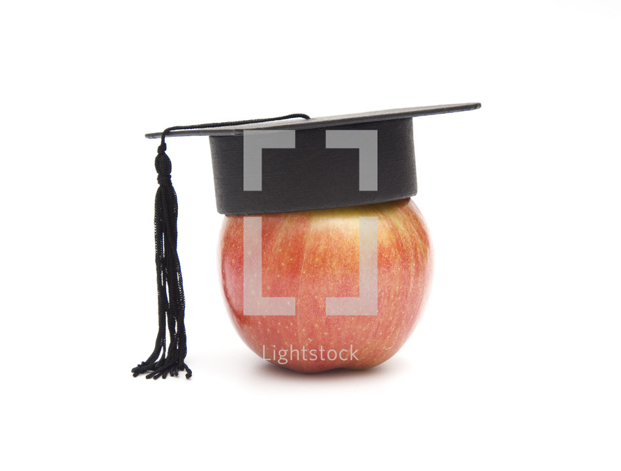 graduation cap on an apple 