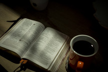 opened Bible and coffee mug 