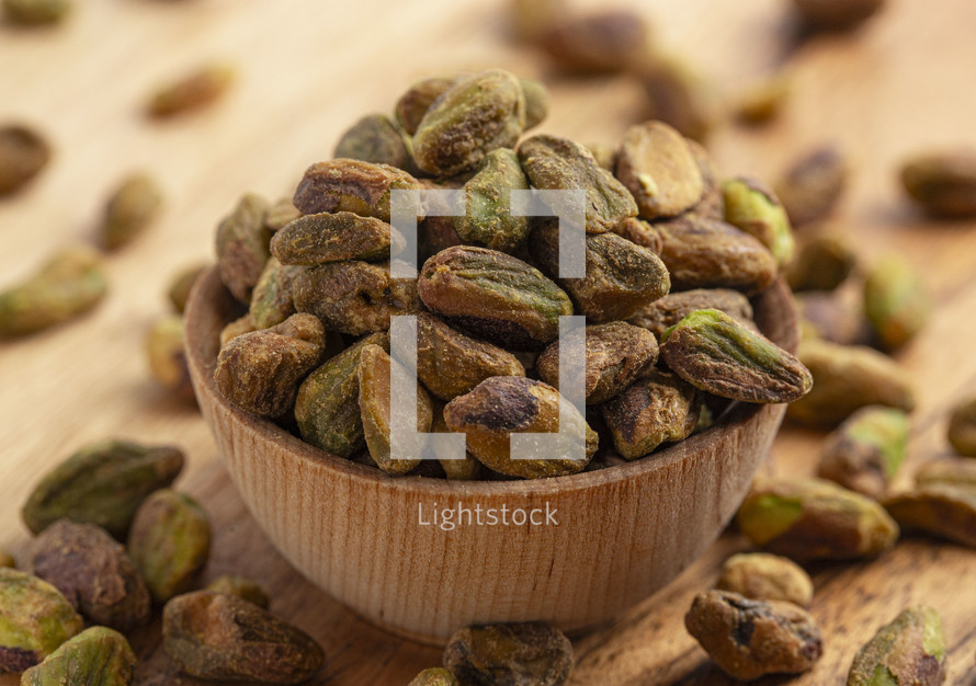 Roasted and Salted Pistachios without Shells on a Wood Table