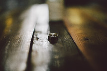 Wedding ring set on a wood table.