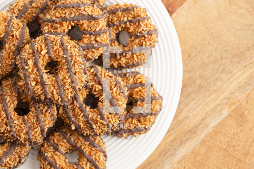 Coconut Caramel Fudge Striped Cookies on a Wood Kitchen Table