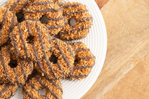 Coconut Caramel Fudge Striped Cookies on a Wood Kitchen Table