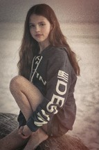 teen girl posing near the ocean 
