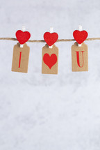red hearts with felt tags on a clothesline 