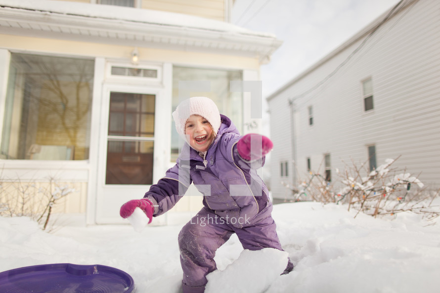 child playing in the snow 