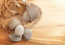 A Sling Shot and Stones on a Wooden Table from the Story of David and Goliath in the BIble 