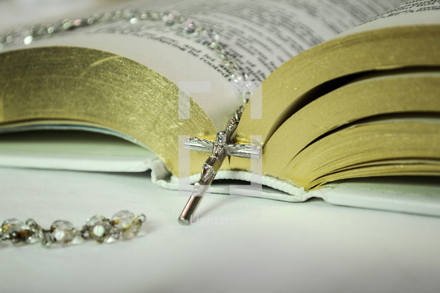 rosary on the pages of a Bible 