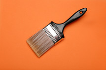 Paintbrush on an orange background.