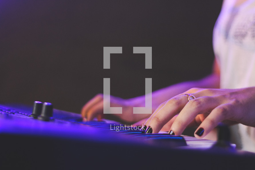 a woman playing a digital keyboard 