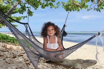 girl in a hammock on a beach 
