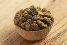 Roasted and Salted Pistachios without Shells on a Wood Table