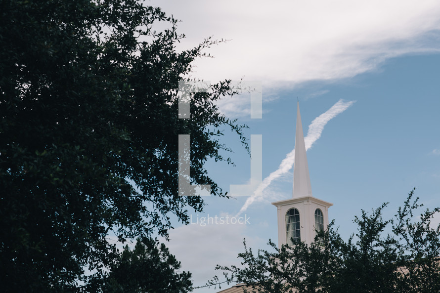 white church steeple in a blue sky