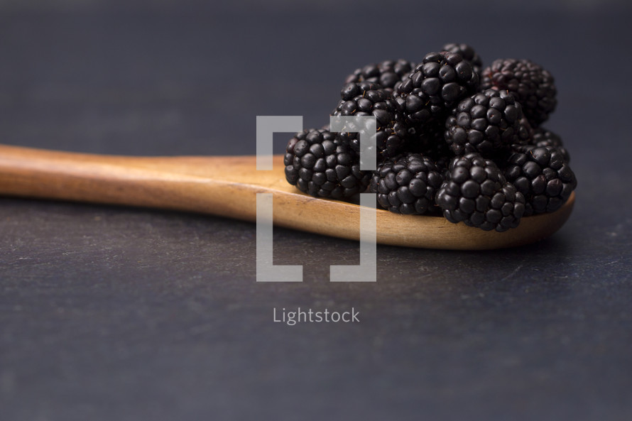 blackberries on a wooden spoon 