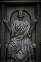 statue of a man with raised hands 