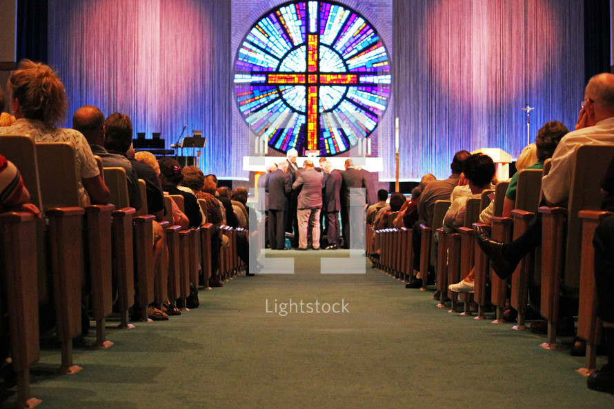 standing at the altar at a church during a worship service 