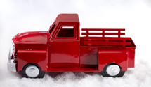 red truck decoration in snow 