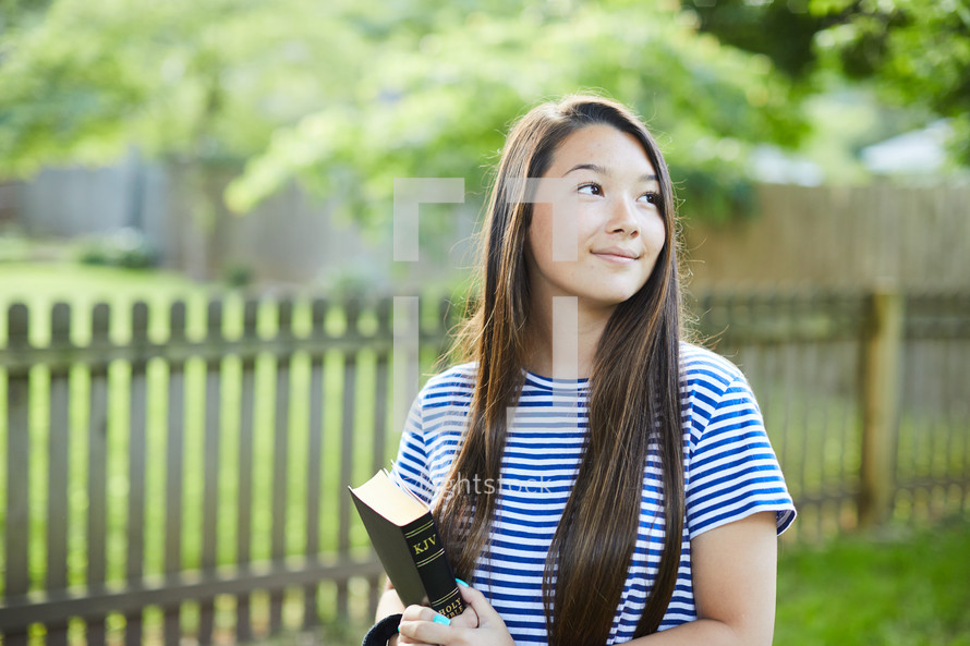 teen girl holding a Bible 