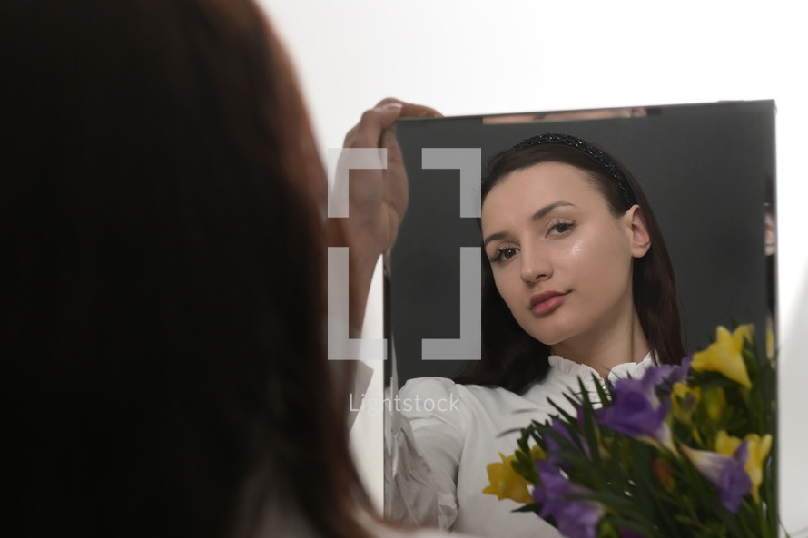 Young Woman and Bouquet Of Freesia Flowers in Mirror