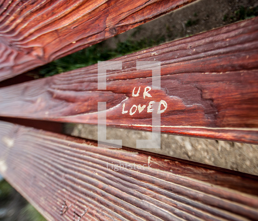UR loved carved in wood of a bench 