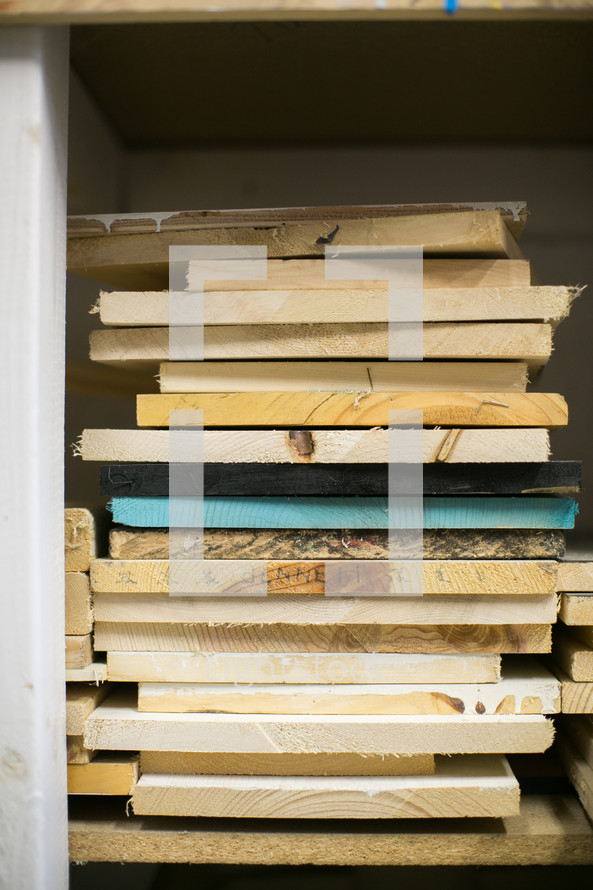 stacks of wood boards on a shelf 