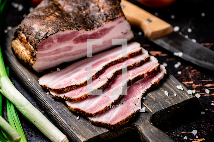 Pork lard cut on a cutting board. Against a dark background. High quality photo